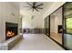 Covered outdoor patio with brick fireplace, ceiling fan, and bar area at 117 Owens Mill Pl, Canton, GA 30115