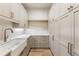 Walk-in pantry with custom cabinets, open shelving, and a sink; providing ample storage space at 117 Owens Mill Pl, Canton, GA 30115