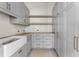 Modern pantry with grey cabinetry, floating shelves, and stainless steel fixtures at 117 Owens Mill Pl, Canton, GA 30115