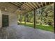 Covered patio features stone flooring, brick wall and wood ceiling at 117 Owens Mill Pl, Canton, GA 30115