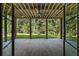 Covered patio features stone flooring, wood ceiling and ceiling fan; view of backyard at 117 Owens Mill Pl, Canton, GA 30115