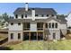 Rear exterior of a two-story home with a covered porch and lush green lawn at 117 Owens Mill Pl, Canton, GA 30115