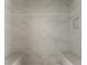 New shower featuring marble tiling, built-in benches, and a recessed shelf at 117 Owens Mill Pl, Canton, GA 30115