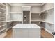 Spacious walk-in closet with built-in shelves, drawers, and central island for organization at 117 Owens Mill Pl, Canton, GA 30115