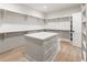 Large walk-in closet with extensive shelving, drawers, and a central island for clothing organization at 117 Owens Mill Pl, Canton, GA 30115