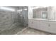Bathroom features a glass door shower, double vanity, and tile floor at 2004 Haley Walk, Woodstock, GA 30188