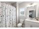 Bathroom features a shower with curtain, vanity, toilet, and large mirror at 2004 Haley Walk, Woodstock, GA 30188