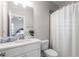 Bathroom features a shower with curtain, vanity, toilet, and large mirror at 2004 Haley Walk, Woodstock, GA 30188