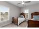 Sun-filled bedroom with two twin beds, carpet, and views of neighborhood at 2004 Haley Walk, Woodstock, GA 30188