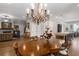 Open-concept dining area with hardwood floors, chandelier, and abundant natural light at 2004 Haley Walk, Woodstock, GA 30188