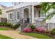 Stunning home highlighting a stone archway, a quaint porch, and beautiful, professionally landscaped grounds at 2004 Haley Walk, Woodstock, GA 30188