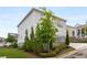 Home exterior with manicured lawn, stone accents, and a charming front garden adding to the curb appeal at 2004 Haley Walk, Woodstock, GA 30188