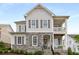 Beautiful two-story home featuring a stone and siding exterior, complemented by lush landscaping at 2004 Haley Walk, Woodstock, GA 30188