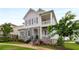 Charming home showcasing a stone facade, dual balconies, manicured landscaping, and a welcoming walkway at 2004 Haley Walk, Woodstock, GA 30188