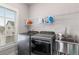 Functional laundry room with modern washer and dryer units, a stainless steel sink, and ample shelving at 2004 Haley Walk, Woodstock, GA 30188
