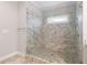 Modern bathroom shower featuring beautiful tile work, glass enclosure, and a convenient built-in bench at 2004 Haley Walk, Woodstock, GA 30188
