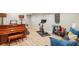 Finished basement featuring a home gym, piano, and comfortable seating area at 700 Winterwind Way, Roswell, GA 30075
