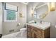 Elegant bathroom featuring a marble countertop vanity, stylish mirror, and decorative lighting fixtures at 700 Winterwind Way, Roswell, GA 30075