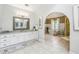A large bathroom featuring a vanity with white cabinets, a large arched opening, and a shower and tub at 700 Winterwind Way, Roswell, GA 30075