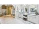 A large bathroom featuring a vanity with white cabinets, a large arched opening, and a shower and tub at 700 Winterwind Way, Roswell, GA 30075