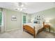 Bright bedroom with two windows, neutral walls, and a wooden bed frame at 700 Winterwind Way, Roswell, GA 30075
