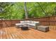 Outdoor deck featuring comfortable seating area and a fire pit, perfect for entertaining at 700 Winterwind Way, Roswell, GA 30075