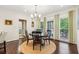 Dining area with large windows and modern chandelier adjacent to an outdoor patio at 700 Winterwind Way, Roswell, GA 30075