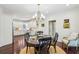 Open-concept dining room with a modern chandelier and direct access to the kitchen at 700 Winterwind Way, Roswell, GA 30075