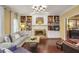 Cozy living room with a fireplace, built-in bookshelves, hardwood floors and contemporary lighting fixtures at 700 Winterwind Way, Roswell, GA 30075