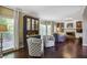 Elegant living room with a fireplace, built-in bookshelves, hardwood floors and oversized windows showcasing the landscape at 700 Winterwind Way, Roswell, GA 30075
