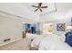 A large bedroom showcasing an attached living room with a ceiling fan and natural light at 700 Winterwind Way, Roswell, GA 30075