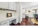 Bright office nook featuring built-in cabinets and desk space adjacent to the kitchen and dining area at 700 Winterwind Way, Roswell, GA 30075