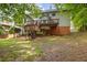 Large backyard with a multilevel deck and wooded surroundings at 2355 Twelvestones Dr, Roswell, GA 30076
