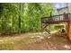 Large backyard featuring a deck and wooded area at 2355 Twelvestones Dr, Roswell, GA 30076