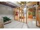 Unfinished basement featuring a walkout door and visible electrical box, ideal for future renovation and personalization at 2355 Twelvestones Dr, Roswell, GA 30076