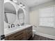 Bathroom features dual sinks, stylish fixtures, and wood-look flooring at 2355 Twelvestones Dr, Roswell, GA 30076