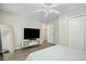 Well-lit bedroom includes ceiling fan, closet, and a full-length mirror at 2355 Twelvestones Dr, Roswell, GA 30076