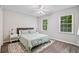 Bright bedroom featuring a ceiling fan, natural light, and a cozy rug at 2355 Twelvestones Dr, Roswell, GA 30076
