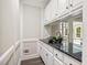 Butler pantry featuring white cabinets and drawers, a granite countertop and a plant accent at 2355 Twelvestones Dr, Roswell, GA 30076