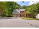 Exterior elevation of a brick two-story home with a three-car garage at 2355 Twelvestones Dr, Roswell, GA 30076