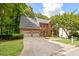 Beautiful brick home featuring a three car garage and double driveway at 2355 Twelvestones Dr, Roswell, GA 30076