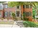 Beautiful brick home featuring a decorative wood front door, manicured landscaping, and stone steps at 2355 Twelvestones Dr, Roswell, GA 30076
