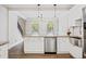 Bright kitchen features stainless steel appliances, granite counters, and hardwood floors at 2355 Twelvestones Dr, Roswell, GA 30076