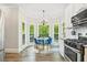 Eat-in kitchen featuring a bay window, hardwood floors, and stainless steel appliances at 2355 Twelvestones Dr, Roswell, GA 30076