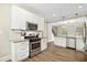 Kitchen featuring white cabinets, stainless steel appliances, and wood-look floors at 2355 Twelvestones Dr, Roswell, GA 30076
