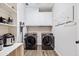 Convenient laundry room with washer, dryer, shelving and cabinets at 2355 Twelvestones Dr, Roswell, GA 30076