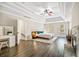 Spacious main bedroom showcasing a tray ceiling, fireplace, and ample natural light from the windows at 2355 Twelvestones Dr, Roswell, GA 30076