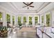 Bright sunroom features tray ceilings, wood floors, and ample natural light at 2355 Twelvestones Dr, Roswell, GA 30076