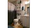 Cozy bathroom with decorative shower curtain, white cabinets and fixtures at 6193 Charring Cross Ct, Lithonia, GA 30058
