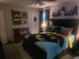 Themed bedroom featuring a Batman comforter, dark wood furniture, and ceiling fan at 6193 Charring Cross Ct, Lithonia, GA 30058